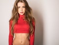 Young sensual model woman in red pose in studio. Royalty Free Stock Photo