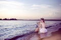 Young Sensual Sea Mermaid Blond Woman With Artistic Makeup and Strasses on Face Posing on Ocean Waves with Silver Crown And Net on Royalty Free Stock Photo