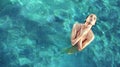 Young, sensual woman realxing in a clear, tropical water