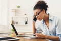 Serious woman consulting by phone at office Royalty Free Stock Photo