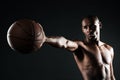 Young serious basketball player holding ball with one hand Royalty Free Stock Photo