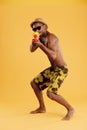 Young serious black man shooting from water gun Royalty Free Stock Photo