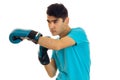 Young serious brunette man in blue boxing gloves practicing isolated on white background Royalty Free Stock Photo