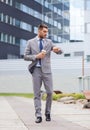 Young serious businessman with paper cup outdoors Royalty Free Stock Photo