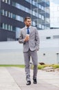 Young serious businessman with paper cup outdoors Royalty Free Stock Photo