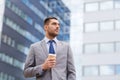 Young serious businessman with paper cup outdoors Royalty Free Stock Photo