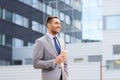 Young serious businessman with paper cup outdoors Royalty Free Stock Photo