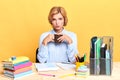 Young serious businesswoman doing paperwork and drinking coffee at office Royalty Free Stock Photo