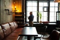 Young serious fashionable man sitting alone in loft-styled cafe Royalty Free Stock Photo