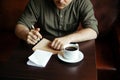 Young serious fashionable man sitting alone