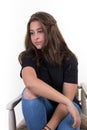 Young serious girl on chair beauty sit woman looking in camera Royalty Free Stock Photo