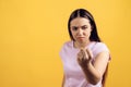 Young serious girl threatens with fist.