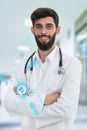 Young serious handsome bearded doctor with white coat and stethoscope. Royalty Free Stock Photo