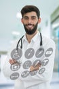 Young serious handsome bearded doctor with white coat and stethoscope. Royalty Free Stock Photo