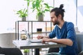 Young serious man working, studying, typing on laptop sitting in coworking cafe Royalty Free Stock Photo