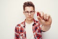 Young serious men in red shirt holding some pill hand