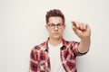 Young serious men in red shirt holding some pill hand