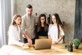 Young team works on laptop at the office desk Royalty Free Stock Photo