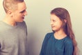 Young serious teen father have a dialog with his small school girl daughter. Happy joyful emotions on toned vintage color