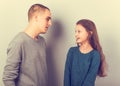 Young serious teen father have a dialog with his small school girl daughter. Happy joyful emotions on toned vintage color