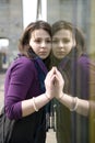 Young serious teen girl outdoor near glass wall Royalty Free Stock Photo