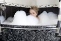 Young serious woman enjoys the bath-foam Royalty Free Stock Photo