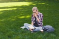 Young serious woman reading book in park Royalty Free Stock Photo