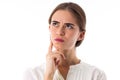 Young seroius woman in white blouse thinking