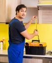 Young service contractor assembling kitchen furniture