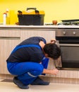 Young service contractor assembling kitchen furniture