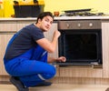 Young service contractor assembling kitchen furniture