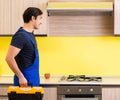 Young service contractor assembling kitchen furniture