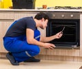 Young service contractor assembling kitchen furniture