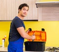 Young service contractor assembling kitchen furniture