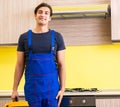 Young service contractor assembling kitchen furniture