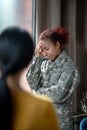 Young servicewoman crying while remembering hard moments