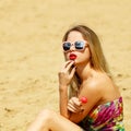 Young sexual woman sucking lollipop on water background. Lifestyle