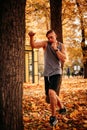 Young athlete practicing blows on a tree in the park