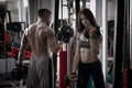 Young athletic man and woman workout with dumbbells in gym Royalty Free Stock Photo