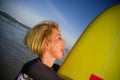 Young beautiful and happy surfer girl holding yellow surf board smiling cheerful enjoying summer holidays in tropical beach w Royalty Free Stock Photo