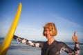 Young beautiful and happy surfer woman holding yellow surf board smiling cheerful enjoying summer holidays in tropical beach Royalty Free Stock Photo