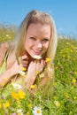 Young blonde on meadow with camomile Royalty Free Stock Photo