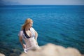 Young blonde woman in bikini near sea