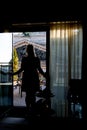 Young blonde woman staying at balcony silhouette Royalty Free Stock Photo