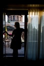 Young blonde woman staying at balcony silhouette Royalty Free Stock Photo