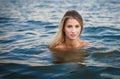 Young blonde woman swimming in ocean with Perfect hair and Royalty Free Stock Photo