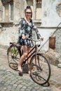 Young brunette girl with old retro style vintage bicycle Royalty Free Stock Photo