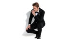 Young sexy businessman slouching, resting his arm on his lap Royalty Free Stock Photo