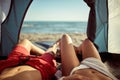 Young sexy couple looking at sea from tent