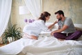 Young sexy couple in underwear having a foreplay in bed in the morinig on valentines day. Intimacy, passion, erotic concept Royalty Free Stock Photo